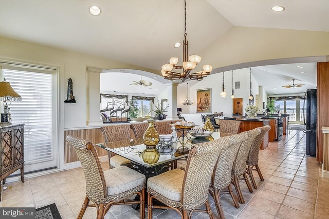 dining space with a notable chandelier and vaulted ceiling