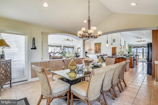 dining space with arched walkways, lofted ceiling, recessed lighting, ceiling fan with notable chandelier, and visible vents