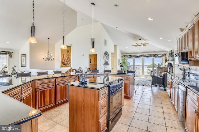 kitchen featuring pendant lighting, dark countertops, open floor plan, and brown cabinets