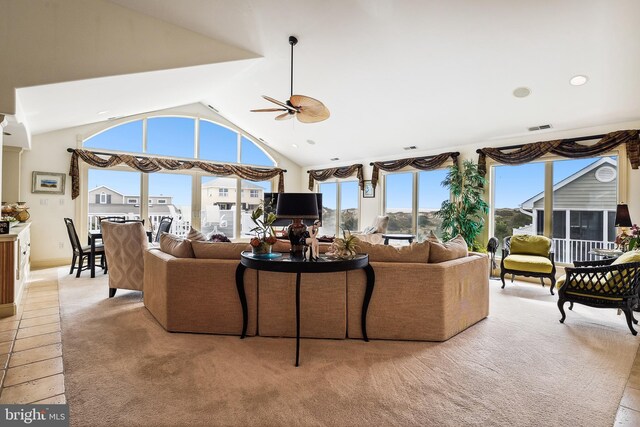 living room with ceiling fan, light tile patterned flooring, and high vaulted ceiling