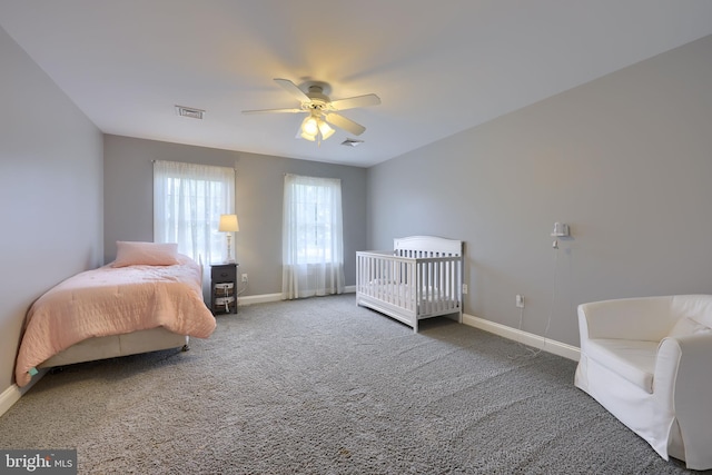 carpeted bedroom with ceiling fan, visible vents, and baseboards