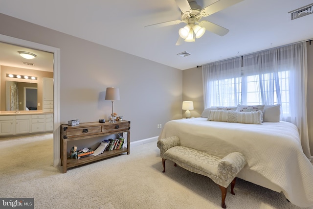 bedroom featuring visible vents and light colored carpet