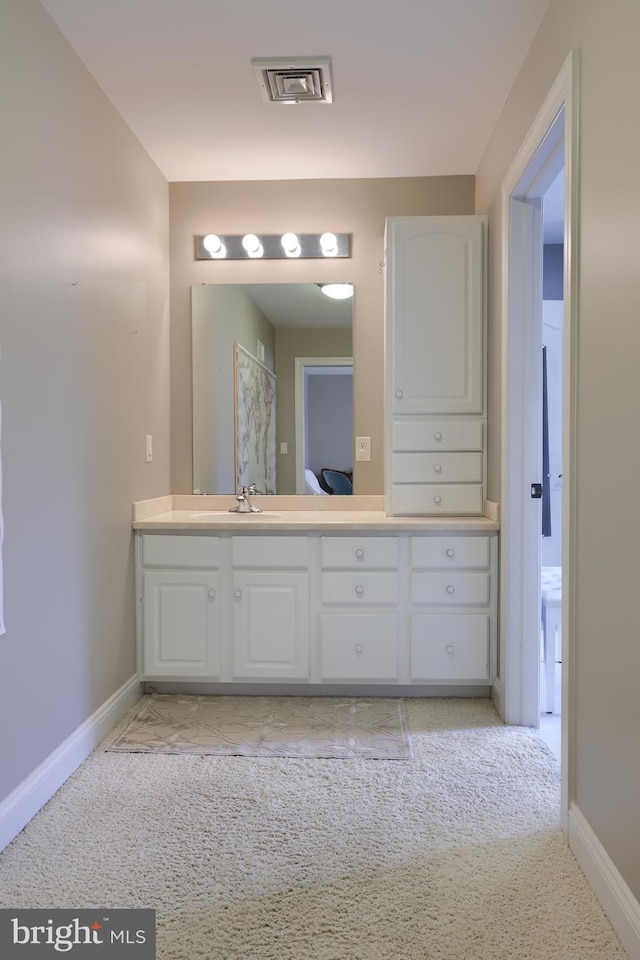 bathroom with visible vents, vanity, and baseboards