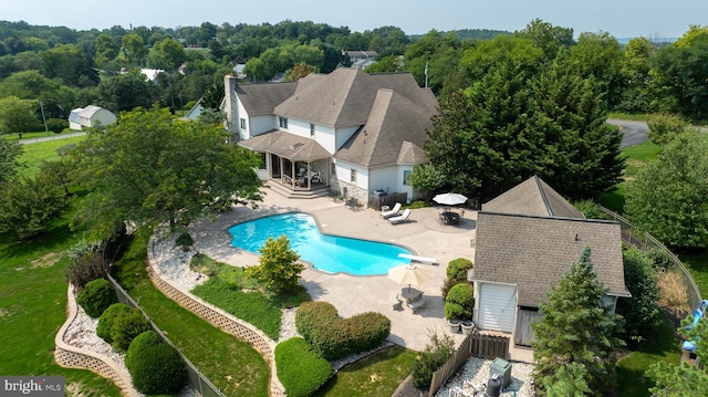 view of pool featuring a fenced in pool, a patio area, an outdoor structure, and a fenced backyard