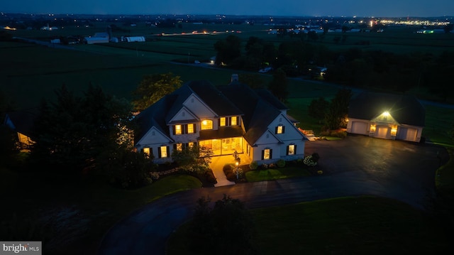 view of front of house featuring a garage, an outdoor structure, and driveway