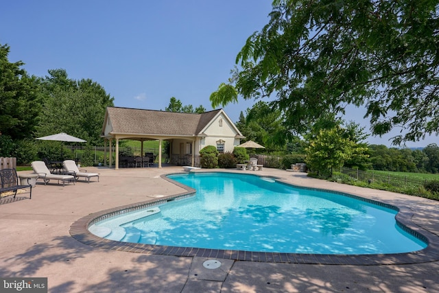 view of swimming pool with a diving board, a patio area, fence, and a fenced in pool