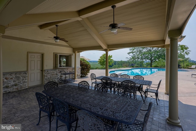 view of patio / terrace featuring an outdoor pool, outdoor dining area, and a ceiling fan