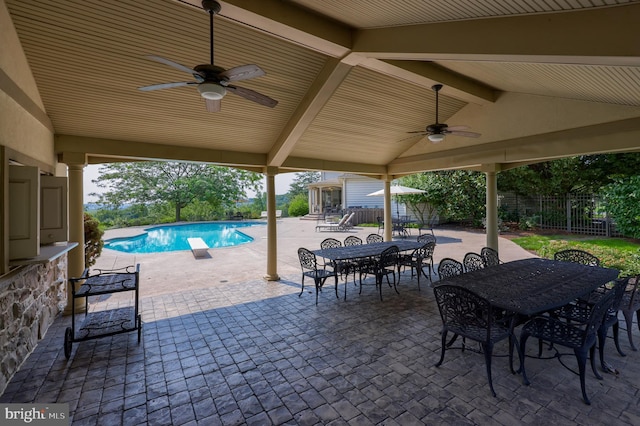 view of patio with ceiling fan, outdoor dining area, fence, and a fenced in pool