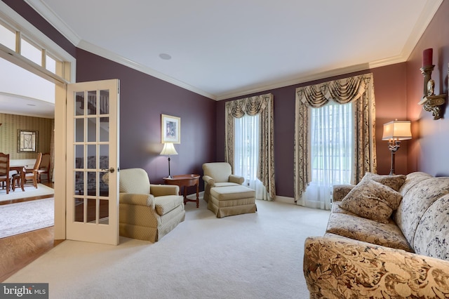 carpeted living room featuring ornamental molding and french doors