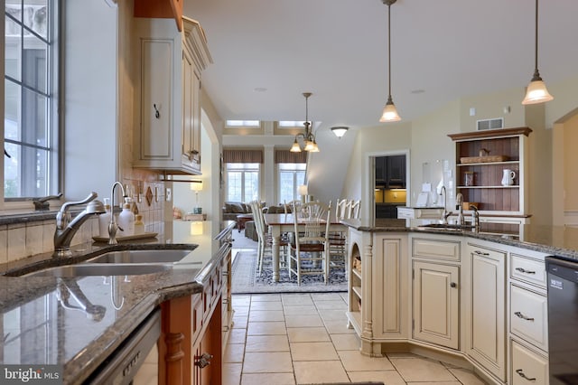 kitchen with dishwasher, open shelves, a sink, and visible vents