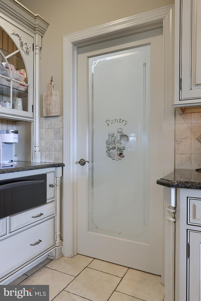 bathroom with decorative backsplash and tile patterned floors