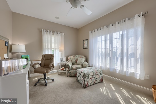 sitting room with vaulted ceiling, carpet floors, and a healthy amount of sunlight