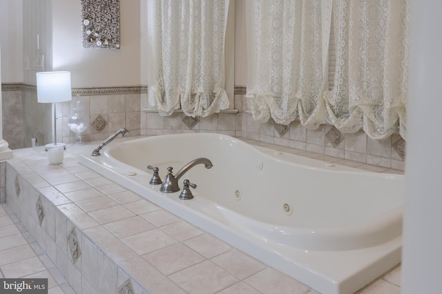 bathroom with a tub with jets