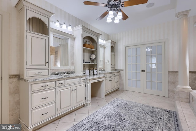 bathroom featuring wallpapered walls, wainscoting, vanity, ornate columns, and tile patterned floors