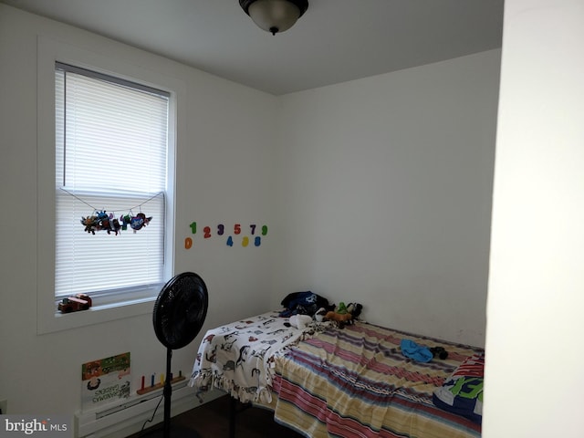 bedroom with a baseboard heating unit