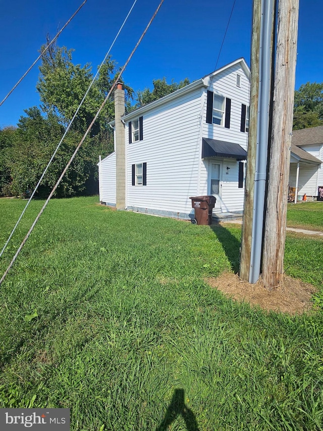 view of side of property with a lawn