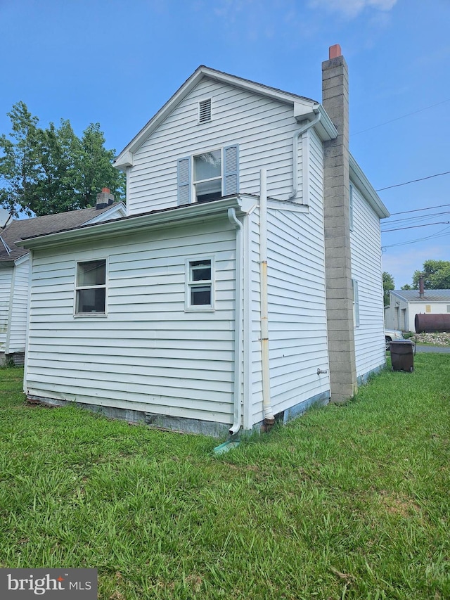 view of side of property with a yard