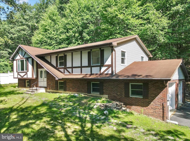 rear view of house with a yard