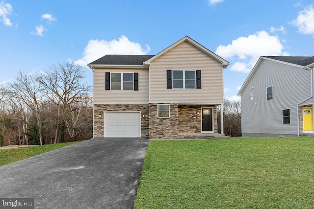 view of front of home with a front yard and a garage