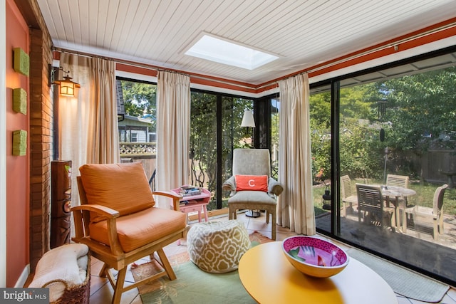 sunroom / solarium featuring a skylight and wood ceiling