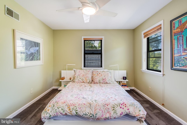 bedroom with ceiling fan and dark colored carpet