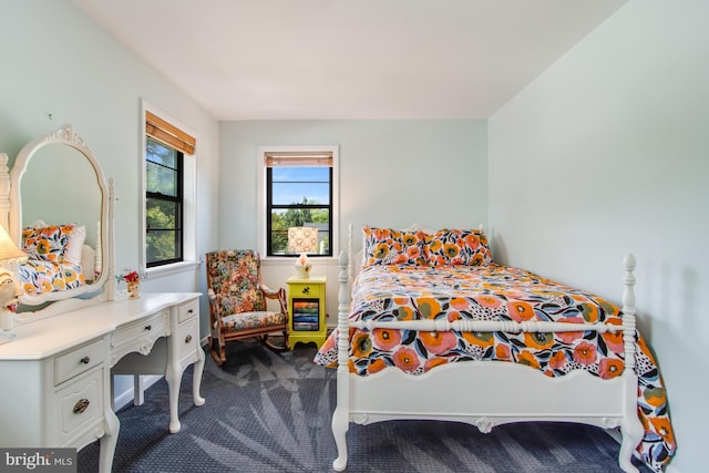 bedroom featuring dark colored carpet