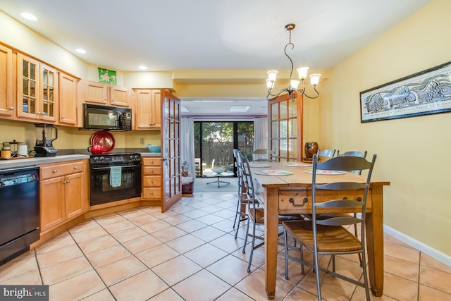 kitchen with pendant lighting, black appliances, light brown cabinets, a chandelier, and light tile patterned floors