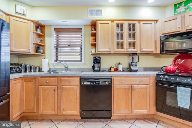 kitchen with light tile patterned floors, sink, light brown cabinets, and black appliances