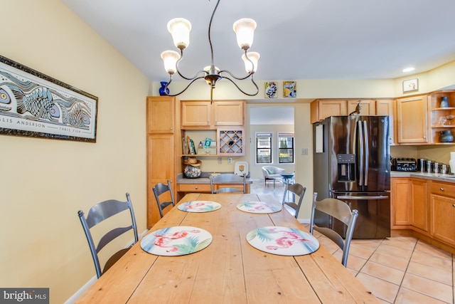 tiled dining space with a notable chandelier