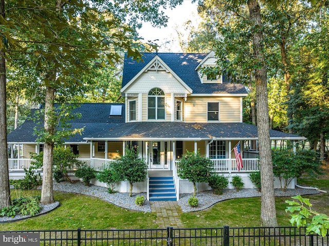 victorian house featuring covered porch and a front lawn