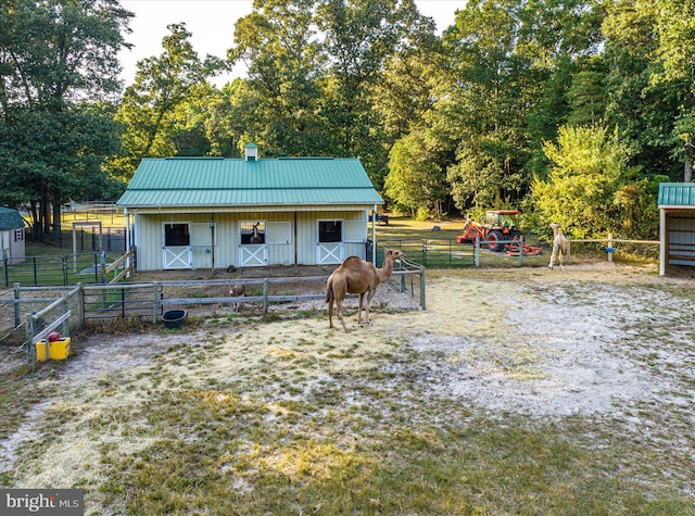 view of horse barn featuring a rural view