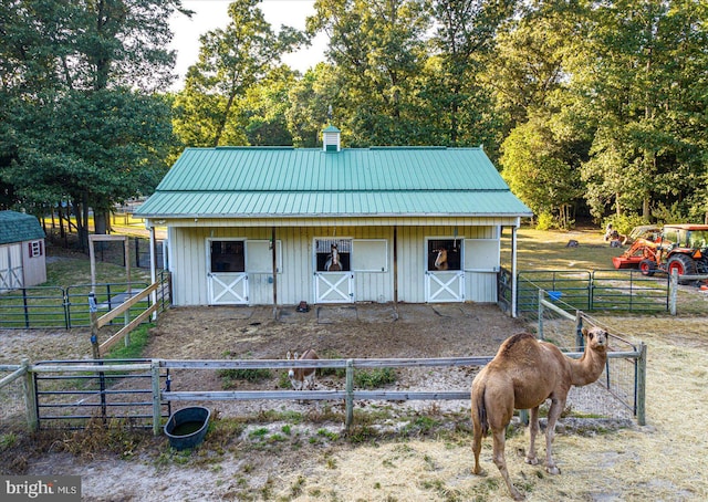 view of horse barn featuring a rural view