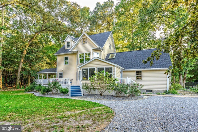 rear view of house with a lawn and a wooden deck