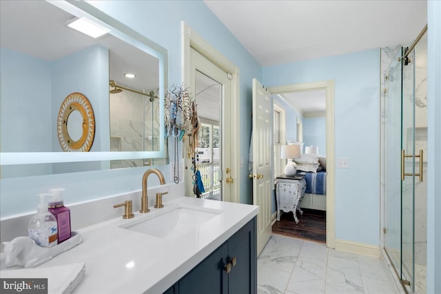 bathroom featuring a shower with door and vanity