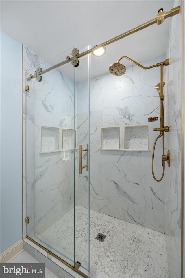 bathroom featuring a shower with shower door