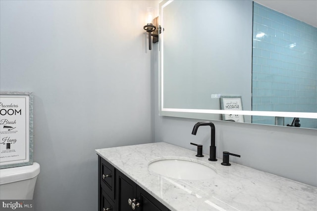 bathroom featuring toilet and vanity