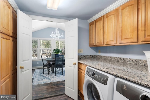 laundry area with cabinets, washing machine and dryer, dark hardwood / wood-style floors, and a chandelier