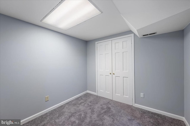 unfurnished bedroom with carpet floors and a closet