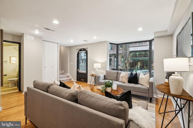 living room featuring expansive windows and light wood-type flooring