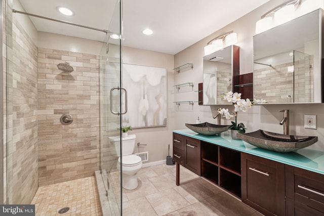 bathroom with toilet, vanity, and walk in shower