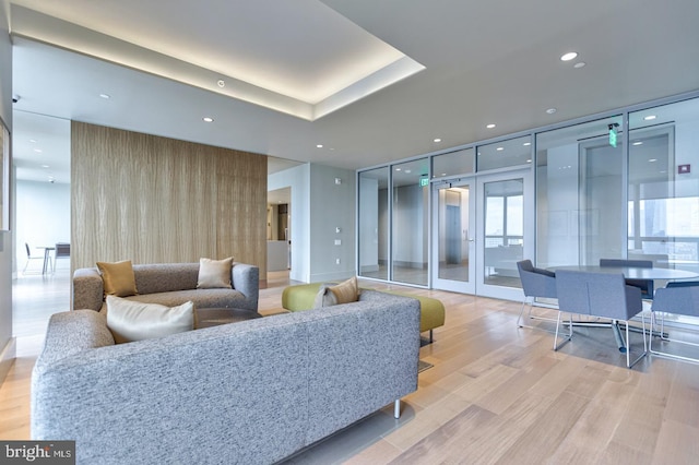 living room featuring expansive windows and light hardwood / wood-style floors