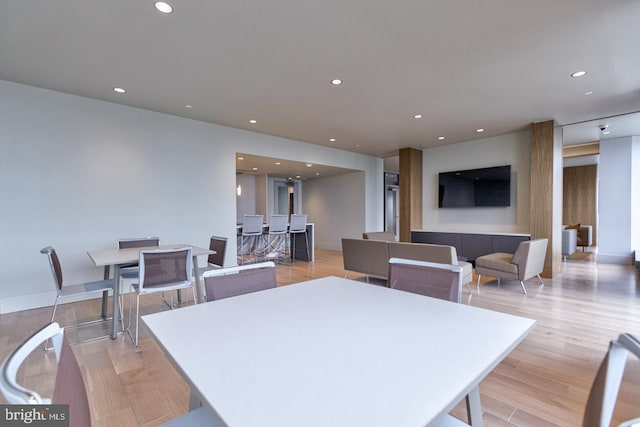 dining space with light hardwood / wood-style floors