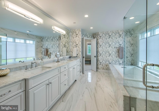 bathroom with tile patterned flooring, shower with separate bathtub, and double sink vanity