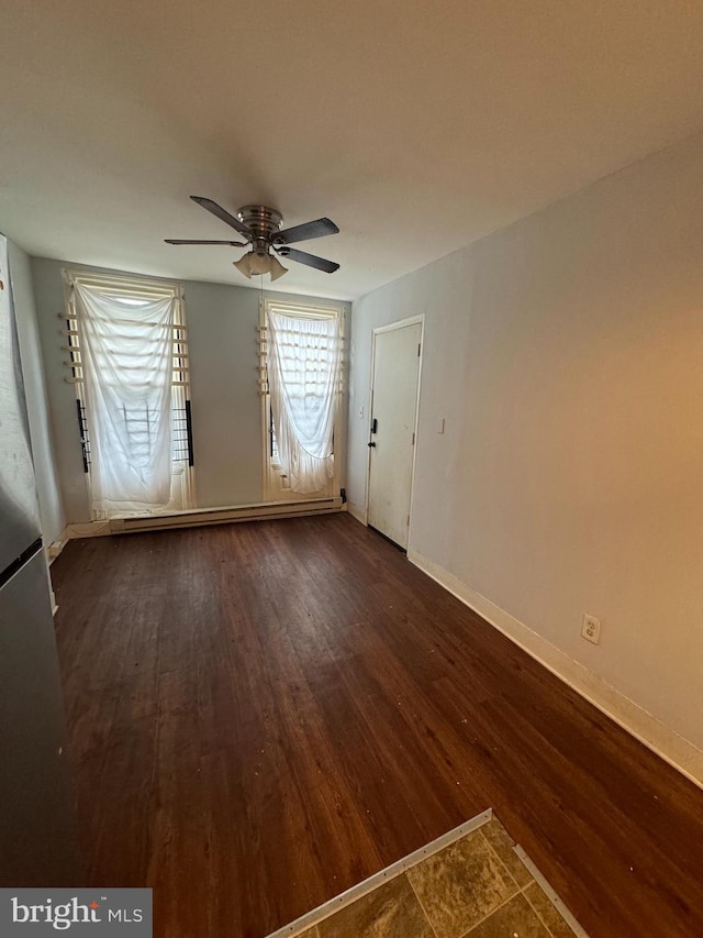 empty room with ceiling fan and hardwood / wood-style floors