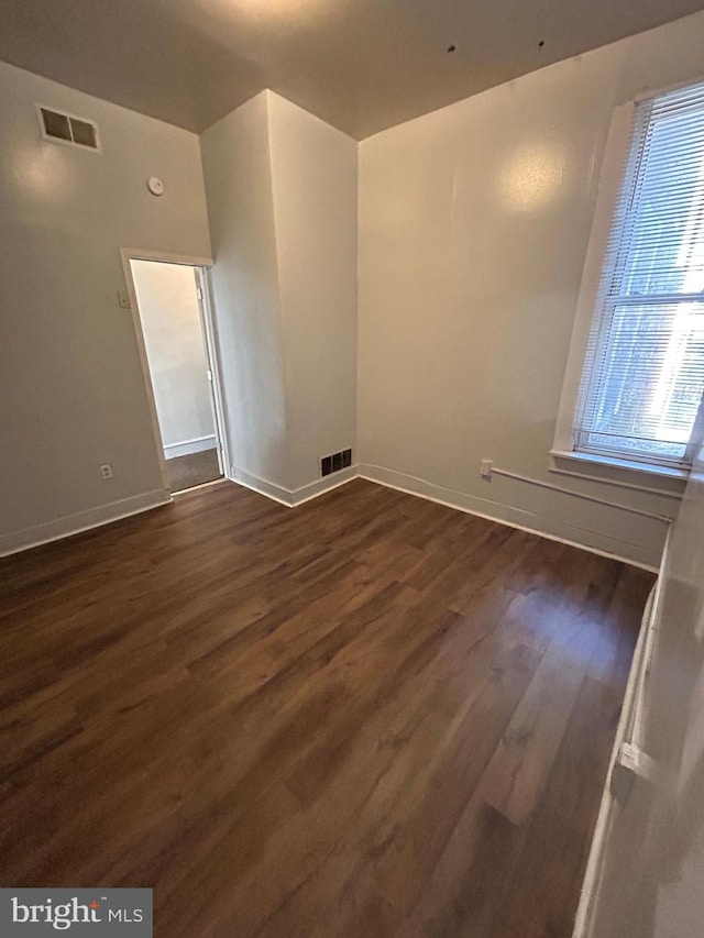 spare room with dark hardwood / wood-style flooring