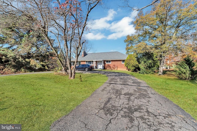 ranch-style home with a front lawn