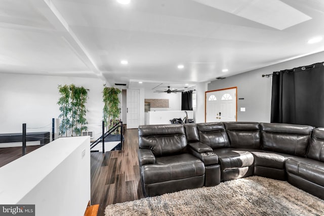 living room with dark wood-type flooring and ceiling fan