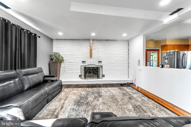 living room featuring a fireplace and wood-type flooring