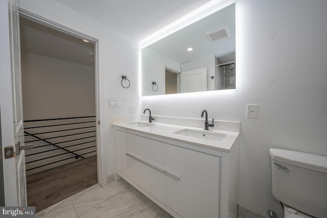 bathroom featuring toilet and vanity