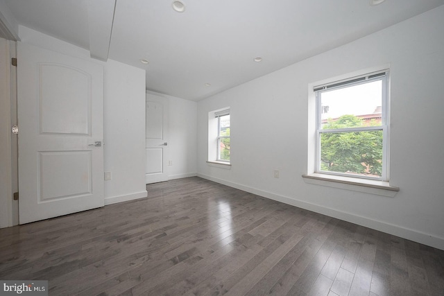 spare room with dark hardwood / wood-style flooring